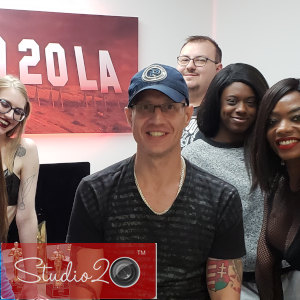 Photo of Douglas Richter surrounded by some of his Los Angeles co-workers in a group shot with Studio20 watermark.
