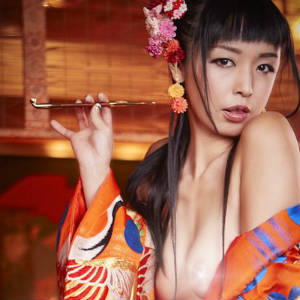 Picture of Marica Hase posing as an opium den Geisha, pipe in her fingers.