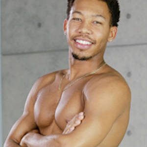 Publicity photo of Ricky Johnson, shirtless and smiling.