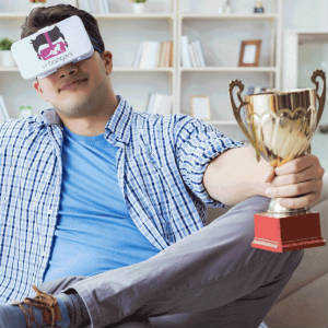 Humourous photo of a man with VR Bangers goggles holding a golden trophy cup.