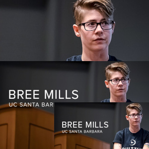 A photo of Bree Mills sitting at a lectern in an Ault Time t-shirt, at UCSB.